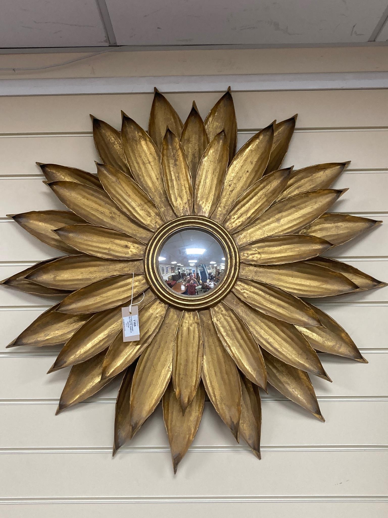 A contemporary gilt metal sunflower convex wall mirror. D-86cm.